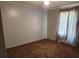 Neutral bedroom featuring neutral colored carpet, paint, ceiling fan and large window covered by drapes at 269 Saddle Rd, Lancaster, SC 29720