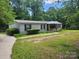 Charming single-story home with a well-maintained lawn and mature trees providing shade at 269 Saddle Rd, Lancaster, SC 29720