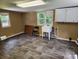 Spacious laundry room with wood-look laminate flooring, white utility sink, and natural light at 269 Saddle Rd, Lancaster, SC 29720