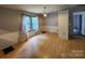 Inviting living room featuring hardwood floors and natural light from the large window with long drapes at 269 Saddle Rd, Lancaster, SC 29720