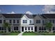 Attractive townhome featuring a gray roof, gray siding, and well-manicured lawn at 2906 Sloan Dr, Charlotte, NC 28208