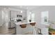 Bright kitchen with gray cabinets, stainless appliances, island with seating, and hardwood floors at 2906 Sloan Dr, Charlotte, NC 28208