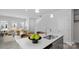 Open concept kitchen with stainless sink, light countertops and view of bright open living area at 2906 Sloan Dr, Charlotte, NC 28208