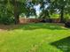 Large, grassy backyard featuring mature trees, offering a serene and private outdoor space at 2939 Lasalle St, Charlotte, NC 28216