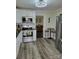 Well-lit kitchen features stainless steel appliances, white cabinetry, and stylish flooring at 2939 Lasalle St, Charlotte, NC 28216