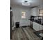 Bright kitchen with white cabinets and stainless steel appliances with door to backyard at 2939 Lasalle St, Charlotte, NC 28216