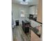 Updated kitchen with white cabinets, a black kitchen island, and stainless steel appliances at 2939 Lasalle St, Charlotte, NC 28216