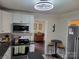 Updated kitchen with stainless steel appliances and a view to the living room bar area at 2939 Lasalle St, Charlotte, NC 28216