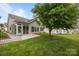 Backyard with patio and lush green grass near the screened in porch at 301 Garner Dr, Salisbury, NC 28146