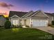 Charming single-Gathering home with a two-car garage, lush lawn, and welcoming curb appeal at dusk at 301 Garner Dr, Salisbury, NC 28146