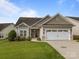 Charming single-Gathering home with a two-car garage, lush lawn, and welcoming curb appeal on a sunny day at 301 Garner Dr, Salisbury, NC 28146