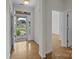 Bright foyer with gleaming hardwood floors, leading to various rooms, and light streaming through the front door at 301 Garner Dr, Salisbury, NC 28146