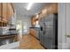 Bright kitchen featuring stainless steel appliances, wood cabinets and outdoor access at 301 Garner Dr, Salisbury, NC 28146