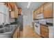 Functional kitchen boasts stainless steel appliances and wooden cabinetry with breakfast bar at 301 Garner Dr, Salisbury, NC 28146