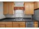 Kitchen features wood cabinets, stainless steel sink, and black countertops at 301 Garner Dr, Salisbury, NC 28146