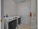 Clean laundry room with modern washer and dryer set, utility sink, and exterior access at 301 Garner Dr, Salisbury, NC 28146