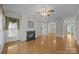 Bright and spacious living room featuring hardwood floors, fireplace, and seamless flow into the dining and entry areas at 301 Garner Dr, Salisbury, NC 28146