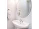 Elegant pedestal sink with a modern faucet and a stylish round mirror, complemented by a towel ring at 3050 Des Prez Ave, Fort Mill, SC 29707