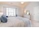 Bright bedroom featuring a vaulted ceiling, a large window, and a comfortable bed with white and blue bedding at 3050 Des Prez Ave, Fort Mill, SC 29707