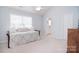 Spacious bedroom with a daybed, neutral carpet, and a glimpse into the en-suite bathroom at 3050 Des Prez Ave, Fort Mill, SC 29707