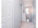 Bright hallway featuring neutral carpet, white trim, and a view of the staircase and window at 3050 Des Prez Ave, Fort Mill, SC 29707