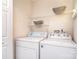Functional laundry room with a washer, dryer, wire shelving, and overhead lighting for convenience at 3050 Des Prez Ave, Fort Mill, SC 29707