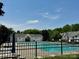 Community pool featuring many lounge chairs and shade umbrellas at 3050 Des Prez Ave, Fort Mill, SC 29707
