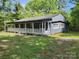 Charming single-story home with a spacious covered porch, nestled in a wooded lot offering privacy at 3225 Sawmill Rd, Hickory Grove, SC 29717