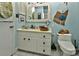Bathroom with a stylish vanity, decorative mirror, and light blue walls at 3430 Rea Rd, Charlotte, NC 28226