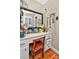 Bathroom vanity area with drawers and storage shelves, natural light, and hardwood floors at 3430 Rea Rd, Charlotte, NC 28226