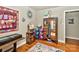 Bedroom featuring a vintage armoire, patterned rug, and artistic wall decor at 3430 Rea Rd, Charlotte, NC 28226