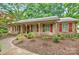 Charming single-story home boasts a well-maintained front yard with mature trees and inviting curb appeal at 3430 Rea Rd, Charlotte, NC 28226