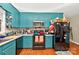 Updated kitchen with teal cabinets, stainless steel appliances, and lots of counter space at 3430 Rea Rd, Charlotte, NC 28226