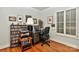 This is a functional home office space with natural light, hardwood floors, and custom shelving at 3430 Rea Rd, Charlotte, NC 28226