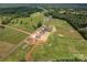 Drone view of multiple homes in the area with green fields and a street going through them at 355 Northbrook Iii School Rd # 10, Vale, NC 28164