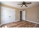 This bedroom features wood-look floors, a ceiling fan, and a walk-in closet at 355 Northbrook Iii School Rd # 10, Vale, NC 28164