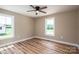 Bright bedroom with wood-look flooring, two windows, and a ceiling fan at 355 Northbrook Iii School Rd # 10, Vale, NC 28164