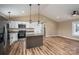 Open kitchen and living area featuring white cabinets, modern appliances, and an island for seating at 355 Northbrook Iii School Rd # 10, Vale, NC 28164
