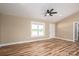 Bright living room featuring wood-look flooring, a ceiling fan, and a large window providing natural light at 355 Northbrook Iii School Rd # 10, Vale, NC 28164