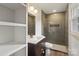 Stylish bathroom with modern vanity, tiled shower, and bronze fixtures at 3937 Tamerlane Dr, Charlotte, NC 28205