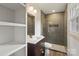 Modern bathroom with shower, tile surround, modern fixtures, and ample storage at 3937 Tamerlane Dr, Charlotte, NC 28205