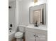 Bathroom with modern vanity, black hardware, and black framed mirror above the sink with updated light fixture above the mirror at 3937 Tamerlane Dr, Charlotte, NC 28205