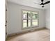 Bedroom featuring wood-look flooring, neutral walls, and a large double window at 3937 Tamerlane Dr, Charlotte, NC 28205