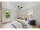 Inviting bedroom featuring hardwood floors, a ceiling fan, and ample natural light at 3937 Tamerlane Dr, Charlotte, NC 28205