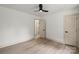 Bedroom with hardwood floors, ceiling fan, neutral paint and molding, and two paneled doors with black hardware at 3937 Tamerlane Dr, Charlotte, NC 28205