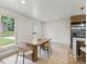 Bright dining area with large windows, modern table, and chairs next to the kitchen at 3937 Tamerlane Dr, Charlotte, NC 28205