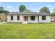 Charming brick home with a well-manicured lawn and inviting front porch exudes curb appeal at 3937 Tamerlane Dr, Charlotte, NC 28205