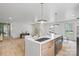 Bright open kitchen with stainless steel appliances and large island with a sink and seating at 3937 Tamerlane Dr, Charlotte, NC 28205