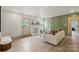 Comfortable living room with decorative fireplace and custom paneled wall and access to the back at 3937 Tamerlane Dr, Charlotte, NC 28205