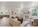 Open living room with fireplace, modern decor, view of kitchen and front door at 3937 Tamerlane Dr, Charlotte, NC 28205